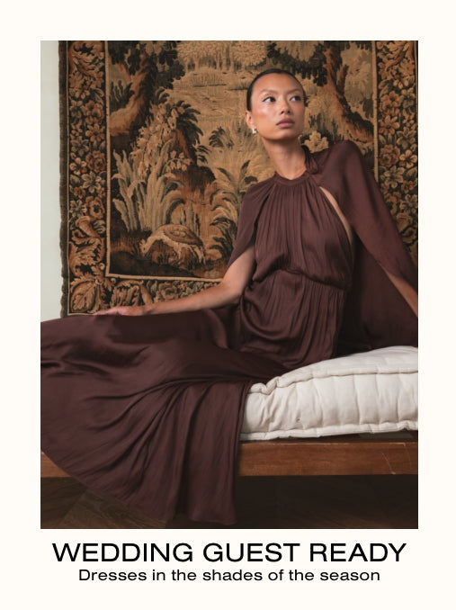Woman in a brown dress sitting on a bed with decorative wall behind her, text 'Wedding Guest Ready' at the bottom.